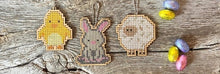 Load image into Gallery viewer, Bunny cross stitch shown with chick and sheep cross stitch, which are also available as kits on the same website