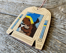 Load image into Gallery viewer, Tree ornament cross stitch on wood featuring squirrel drinking coffee on ugly Christmas sweater FREE SHIPPING