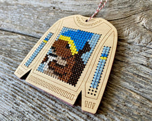 Load image into Gallery viewer, Tree ornament cross stitch on wood featuring squirrel drinking coffee on ugly Christmas sweater FREE SHIPPING

